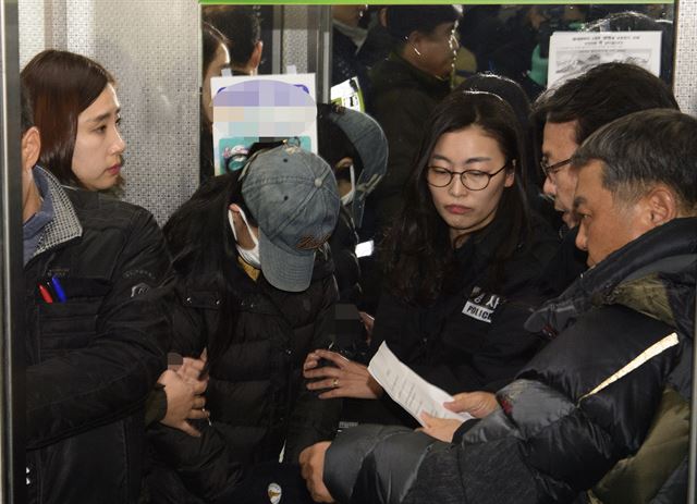 광주 북구 두암동에서 화재를 일으켜 세 남매를 숨지게한 혐의로 구속된 20대 엄마 정모씨가 3일 오후 현장검증을 하기 위해 아파트에 도착해 고지를 받고 있다. 연합뉴스