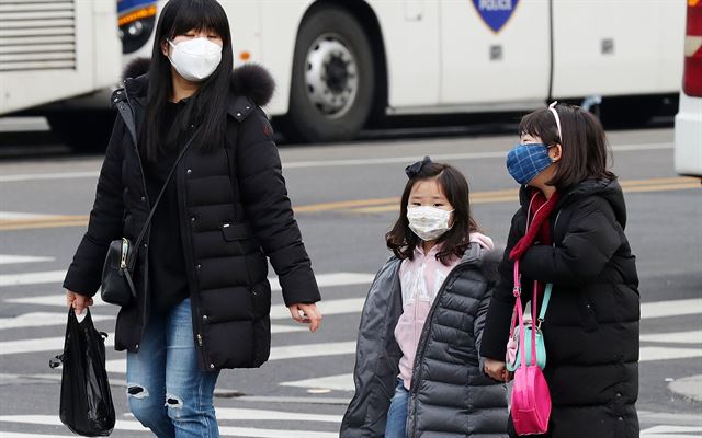 20일 오전 서울 광화문 인근에서 한 가족이 마스크를 착용하고 걷고 있다. 이날 서울 초미세먼지 농도는 오전까지는 '보통'수준을 보이다 오후부터 높아져 '매우 나쁨'수준까지 나타냈다. 연합뉴스