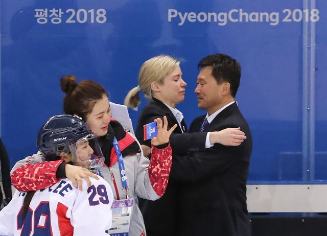 20일 강원도 강릉시 관동하키센터에서 열린 2018 평창동계올림픽 여자 아이스하키 7∼8위 순위 결정전 남북 단일팀 대 스웨덴 경기가 1대6 단일팀 패배로 끝난 뒤 단일팀 새러 머리 총감독과 북측 박철호 감독이 포옹하며 서로를 격려하고 있다. 연합뉴스