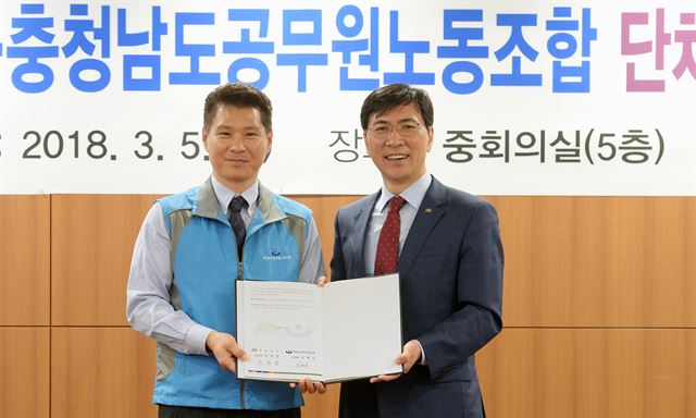 김태신(왼쪽) 충남공무원노조위원장과 안희정 지사가 5일 도청 중회의실에서 ‘단체협약서’ 최종 서명을 하고 기념촬영을 하고 있다. 충남도 제공