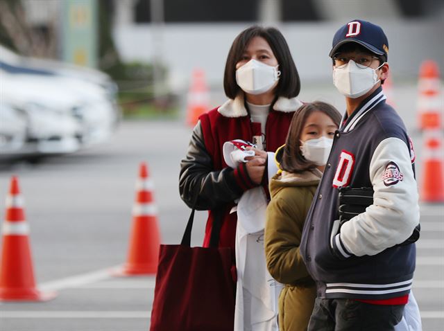 황사와 뒤섞이면서 미세먼지 농도가 '나쁨'을 기록한 6일 오후 서울 잠실야구장을 찾은 팬들이 마스크를 쓰고 있다. 이날 예정됐던 NC 다이노스와 두산 베어스의 경기는 프로야구 역사상 처음으로 미세먼지 영향으로 취소됐다. 연합뉴스