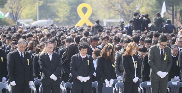 16일 오후 경기 안산시 화랑유원지 내에서 열린 ‘4.16세월호 참사 희생자 정부 합동 영결ㆍ추도식’에서 유가족들이 희생자들에 대한 묵념을 하고 있다. 류효진 기자