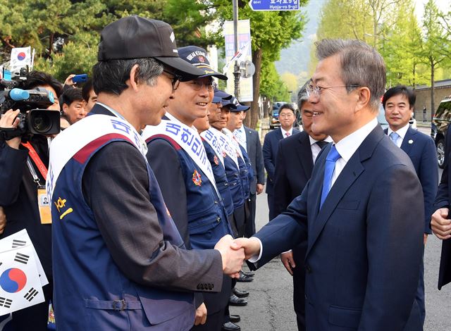 문재인 대통령이 27일 오전 서울 종로구 정부서울청사 창성동 별관 앞에서 남북정상회담 성공을 기원하는 시민과 재향군인회 관계자들과 인사하고 있다. 연합뉴스