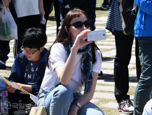 제474회 한국일보 거북이마라톤 '소셜벤처 위크 기념 남산 걷기대회'가 19일 서울 남산 백범광장에서 열린 가운데 식후행사로 사회적기업 소속의 걸그룹 연습생 '플로어스'가 율동적인 공연 모습을 한 외국인 참가자가 핸드폰으로 촬영하고 있다. 홍인기 기자