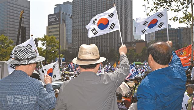 [저작권 한국일보] 6일 오후 서울 종로구 교보빌딩 앞에서 열린 '자유민주주의 수호 국민대회'에서 참석자들이 태극기를 흔들고 있다. 배우한 기자