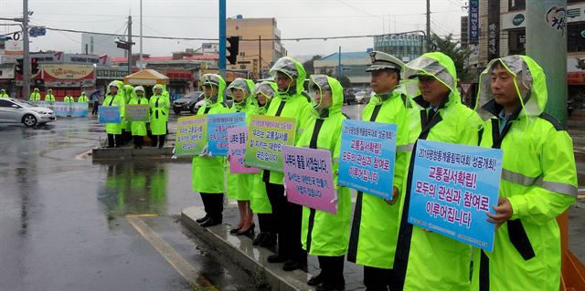 새마을교통봉사대 경남지역대 대원들이 비가 오는 날 교차로에서 교통안전 캠페인을 하고 있다. 새마을교통봉사대는 전국에서 25,000여명의 회원이 교통안전 캠페인, 사고다발지역과 등하굣길 안전지킴 활동 등을 한다. 새마을교통봉사대 제공