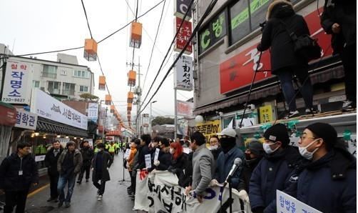 맘편히장사하고픈상인모임 회원들이 1월 15일 오전 서울 종로구 서촌 '본가궁중족발' 앞에서 법원 집행관이 강제집행을 하지 못하도록 가게 앞을 막아서고 있다. 연합뉴스