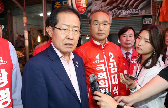 지난 9일 자유한국당 홍준표 대표가 해운대구 반송골목시장에서 이 지역 국회의원 보궐선거에 출마한 김대식 후보, 지방선거 후보 지원 유세 중 취재진과 인터뷰 하고 있다. 연합뉴스