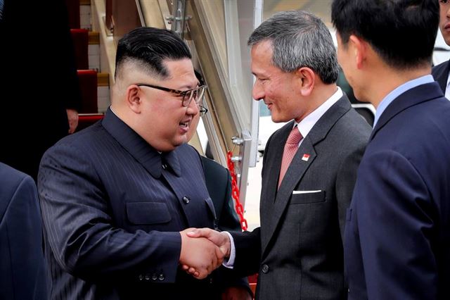 김정은 북한 국무위원장이 10일 오후(현지시간) 싱가포르 창이 공항에서 비비안 발라크리쉬난 싱가포르 외무장관의 영접을 받고 있다. 연합뉴스