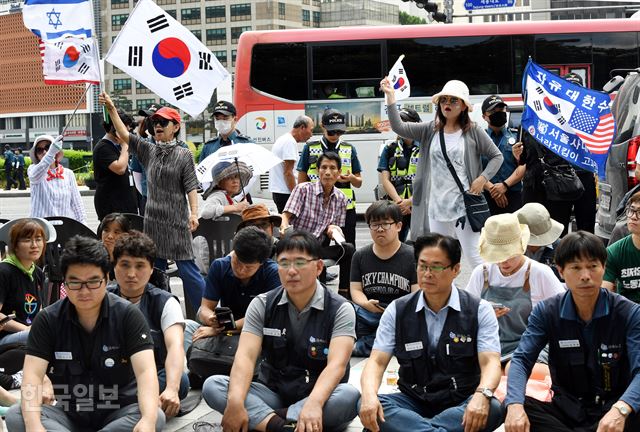 4일 오전 서울 중구 대한문 앞에서 고(故) 쌍용자동차 해고 노동자 고(故) 김모씨를 추모하기 위해 분향소가 설치된 가운데 보수단체 회원들이 태극기를 흔들며 분향소 철수를 요구하고 있다. 고영권 기자