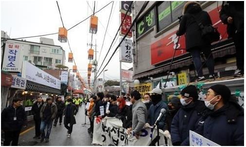 맘편히장사하고픈상인모임 회원들이 지난 1월 15일 오전 서울 종로구 서촌 '본가궁중족발' 앞에서 법원 집행관이 강제집행을 하지 못하도록 가게 앞을 막아서고 있다. 연합뉴스