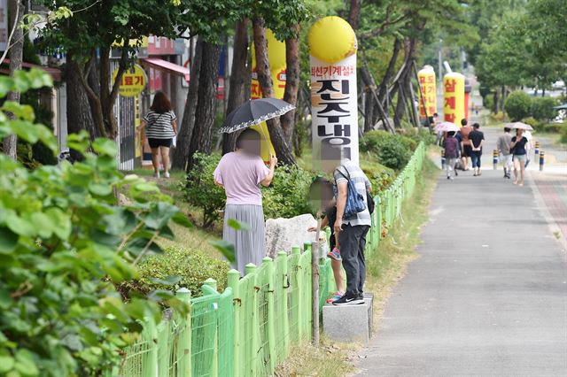 지난 22일 오후 경남 양산부산대병원 정문 맞은편 공공공지에 설치된 펜스를 사람들이 넘어다니고 있다. 전혜원 기자