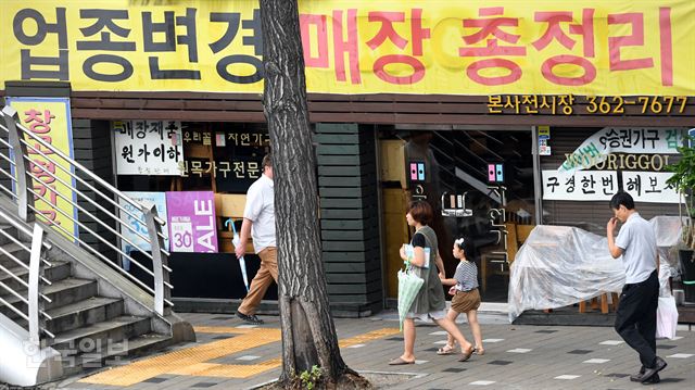 24일 오후 업종 변경을 위해 대규모 할인 판매를 하는 서울 서대문구 대현동의 한 가구매장 앞을 시민들이 지나가고 있다. 고영권기자