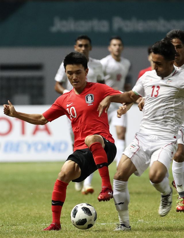 아시안게임 남자 축구대표팀 황인범(10번)이 23일 인도네시아 치카랑 위바와 묵티 스타디움에서 열린 자카르타-팔렘방 아시안게임 축구 16강 이란의 경기에서 볼 다툼을 하고 있다. 치카랑=연합뉴스