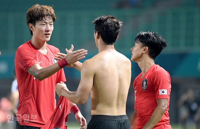 '2018 자카르타-팔렘방 아시안게임 남자 축구 8강전' 한국-우즈베키스탄 경기에서 연장 후반 종료 직전 황희찬(가운데)이 페널티킥을 넣은 뒤 해트트릭을 성공한 황의조와 악수를 하고 있다. 오른쪽은 이승우.