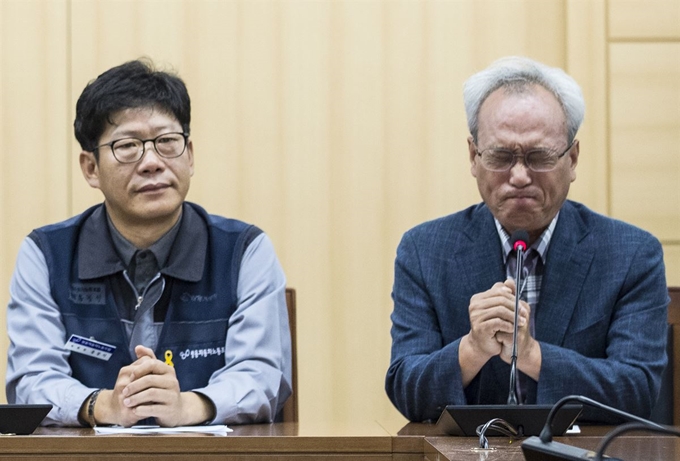 문성현 경제사회노동위원장(오른쪽)이 14일 오전 서울 광화문 경제사회노동위 대회의실에서 열린 쌍용차 노사 해고자 복직 잠정 합의에서 울먹이고 있다. 왼쪽은 홍봉석 쌍용자동차 노조위원장. 연합뉴스