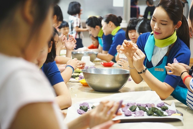 에어부산 캐빈승무원들이 17일 오후 부산 동래구 ‘우리집원’을 찾아 어린이들과 추석맞이 송편을 만들고 있다. 에어부산 제공