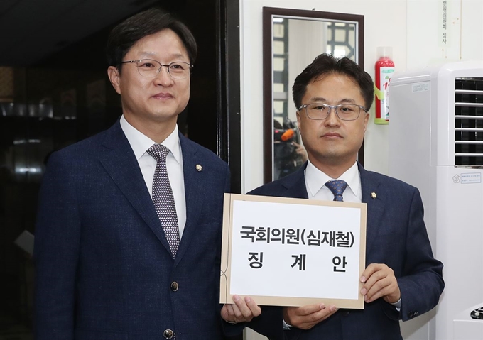 더불어민주당 강병원 원내대변인(왼쪽)과 국회 기획재정위원회 간사인 김정우 의원이 28일 오후 심재철 자유한국당 의원의 국가기밀탈취 관련 윤리위 징계 요청안을 국회 의안과에 제출하고 있다. 연합뉴스