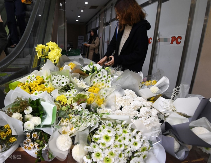 21일 오후 서울 강서구의 한 PC방 앞에 '강서PC방 살인사건'의 피해자를 추모하는 한 시민이 국화를 놓고 있다. 홍인기 기자