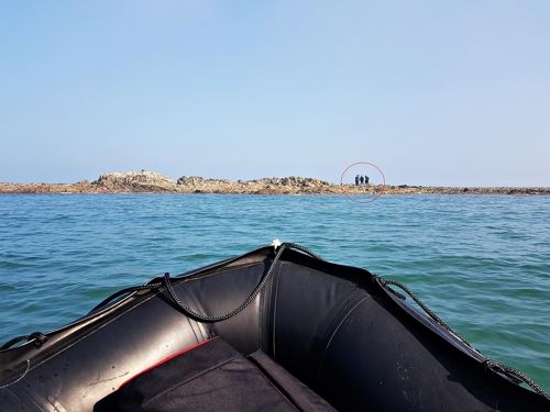 4일 해경이 충남 당진시 석문면 도비도 인근 갯바위에 고립된 낚시객을 구조하러 가는 모습. 빨간 원 안에 고립된 낚시객이 보인다. 평택해경 제공. 연합뉴스.