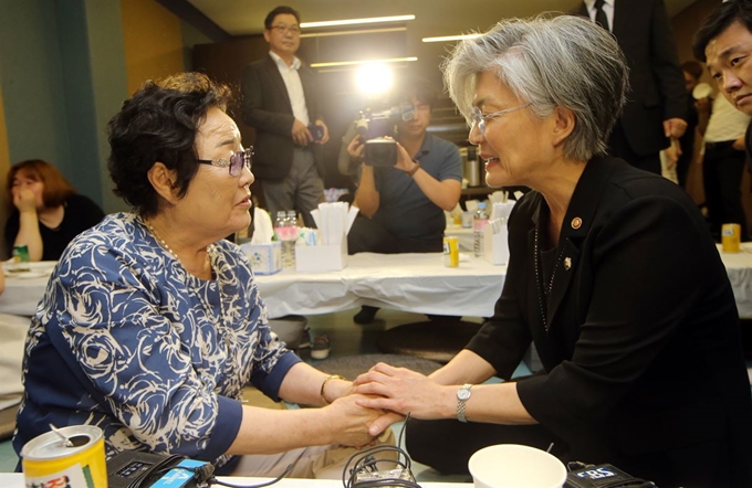 강경화 외교부 장관이 지난해 7월 경기 성남시 분당차병원 장례식장에 차려진 위안부 피해자 김군자 할머니 빈소를 찾아 같은 위안부 피해자 이용수 할머니의 손을 잡고 위로하고 있다. 성남=연합뉴스