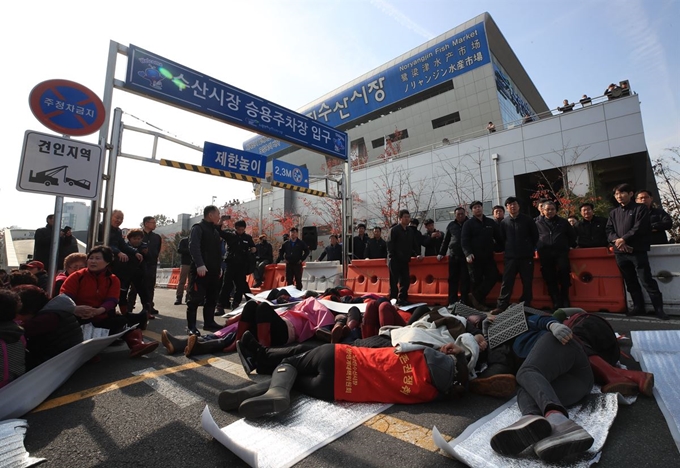 수협이 구 노량진시장 전역에 단전·단수 조치를 한 5일 오전 서울 노량진 수산시장 주차장 입구를 구 시장 상인들이 막고 있다. 연합뉴스