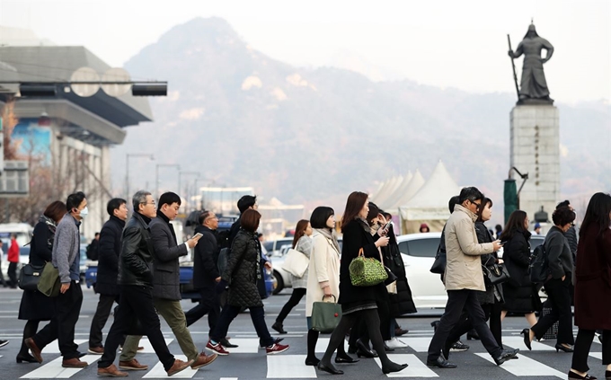 19일 오전 서울 광화문 네거리에서 출근길 시민들이 몸을 움츠린 채 발걸음을 옮기고 있다. 뉴스1