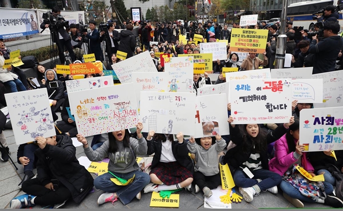 정부가 화해치유재단을 해산한다고 공식 발표한 21일 서울 종로구 옛 일본대사관 앞에서 열린 일본군 위안부 문제 해결을 위한 정기 수요시위 참가자들이 구호를 외치고 있다. 연합뉴스