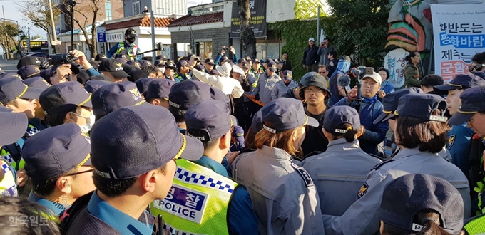 [저작권 한국일보]지난달 11일 오전 ‘2018 대한민국 해군 국제관함식’ 이 열린 제주 서귀포시 제주해군기지 인근 강정마을 내에서 관함식 개최를 반대하는 강정주민들과 시민사회단체들이 경찰들과 몸싸움을 벌이는 등 마찰을 빚었다. 김영헌 기자.