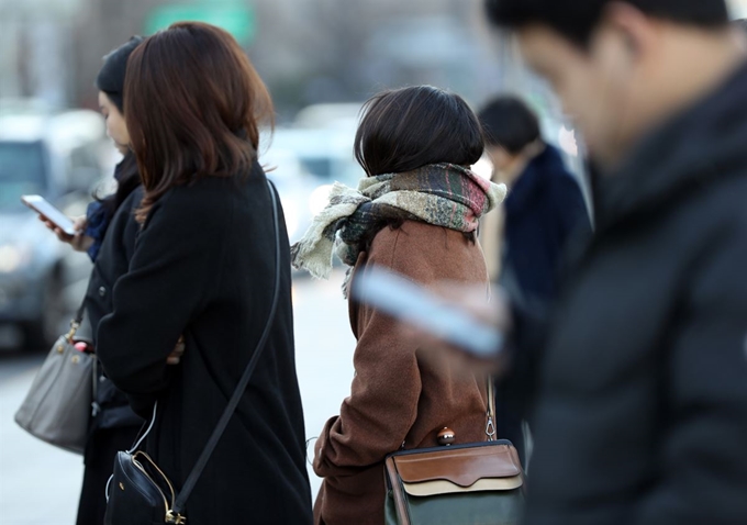 추위가 엄습한 22일 오전 두꺼운 복장을 한 시민이 서울 광화문 사거리를 지나고 있다. 연합뉴스