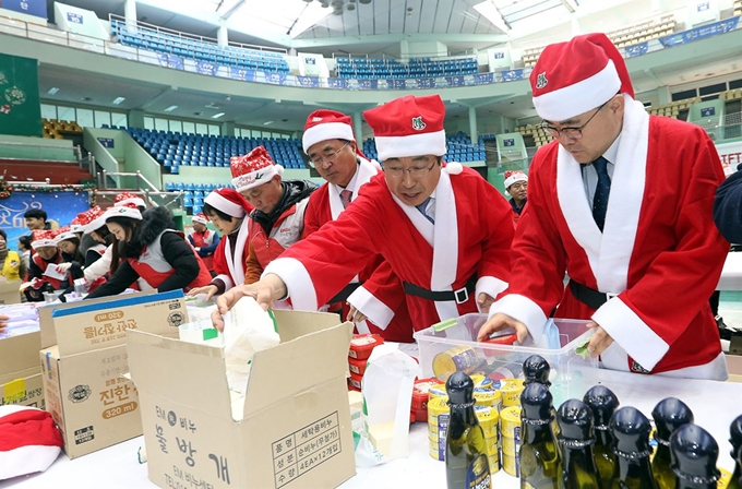 17일 열린 ‘구호물품 나눔 대축제’에서 황윤철(사진 오른쪽 두 번째) BNK경남은행장과 허성무(사진 오른쪽 첫 번째) 창원시장이 자원봉사자들과 함께 구호물품을 포장하고 있다. 경남은행 제공