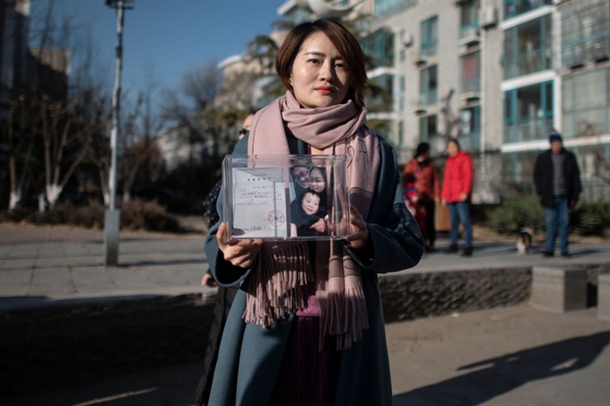 중국의 저명한 인권변호사인 왕콴장의 아내 리원쭈가 구금된 남편을 포함한 인권 변호사들을 탄압하는 것에 항의하기 위해 머리를 삭발하기 전 취재진을 보며 포즈를 취하고 있다. AFP=연합뉴스