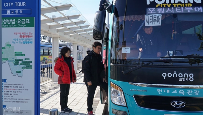 [저작권 한국일보]전남 순천에서 온 김상연(59)씨 부부가 경북 포항KTX역사에서 정차 중인 포항시티투어 버스에 탑승하고 있다. 포항=김정혜기자 kjh@hankookilbo.com