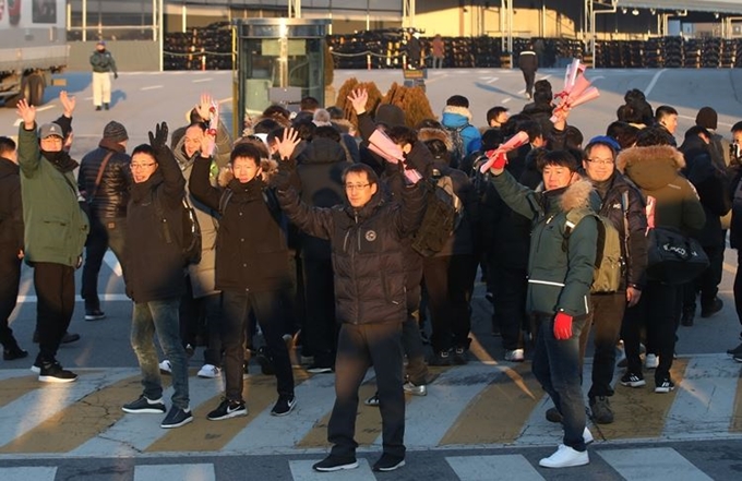 10년 만에 복직한 쌍용차 해고 노동자들이 31일 오전 경기 평택시 쌍용자동차 평택공장으로 출근하며 손을 흔들고 있다. 연합뉴스