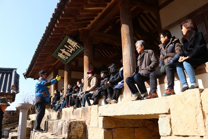 지난달 20일 안동시티투어 관광객들이 경북 안동시 풍천면 병산리 병산서원 입교당에 앉아 권혁대 안동시티투어 대표의 설명을 듣고 있다. 류수현기자 suhyeonryu@hankookilbo.com