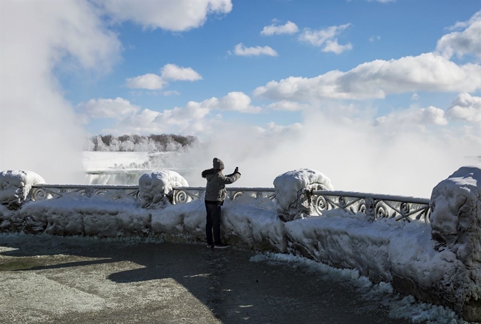 미 중북부, 캐나다에 ‘폴라 보텍스(polar vortex•북극 소용돌이)’으로 인한 기록적인 한파가 강타한 가운데 31일(현지시간) 캐나다 온타리오주 나이아가라 폭포에서 한 방문객이 얼음으로 덮인 호스슈 폭포를 촬영하고 있다. AP 연합뉴스