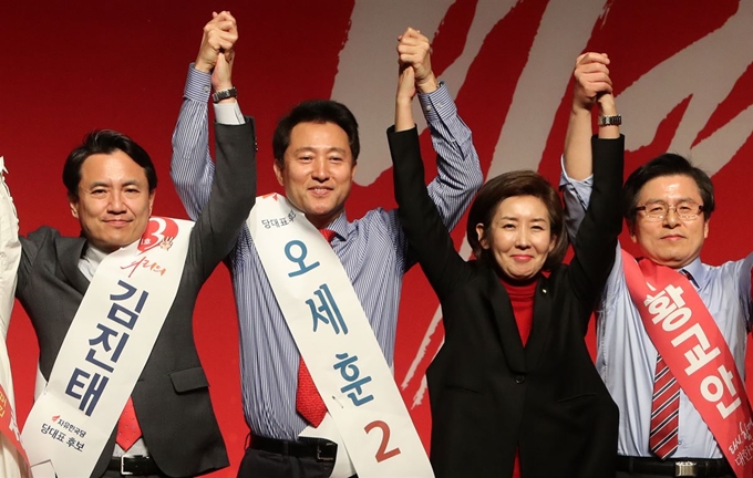 자유한국당 2.27전당대회 당 대표에 도전하는 김진태(왼쪽부터),오세훈, 황교안 후보가 18일 대구 엑스코에서 열린 대구&middot;경북 합동연설회에서 단상에 올라 나경원 원내대표와 손을 맞잡아 들어올리고 있다. 뉴스1