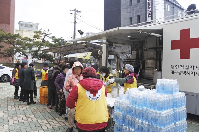 [저작권 한국일보] 대구 중구 대안성당 앞마당, 대보아파트 이재민들이 대한적십자사 대구광역시지사 자원봉사자들이 배급하는 점심식사를 받고 있다. 윤희정기자 yooni@hankookilbo.com