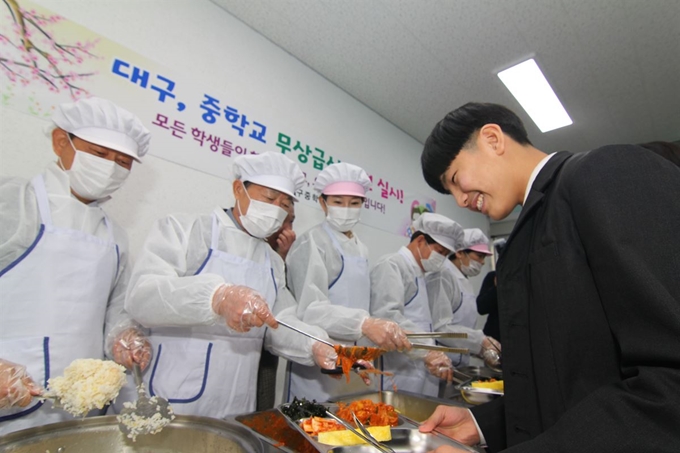 대구 중학교 무상급식이 이뤄지는 첫날인 4일 권영진 대구시장과 배지숙 대구시의회 의장, 강은희 대구교육감, 류한국 서구청장이 서구 서대구중학교 구내식당에서 학생들에게 배식을 하고 있다. 김민규기자 whitekmg@hankookilbo.com