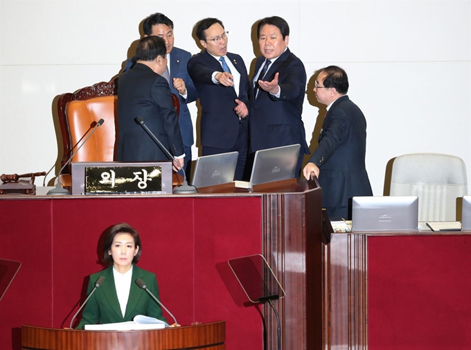 자유한국당 나경원 원내대표가 12일 오전 국회 본회의장에서 교섭단체 대표연설을 하던 중 정부가 북한의 대변인이라는 식의 발언을 하자 더불어민주당 홍영표 원내대표(뒷줄 가운데)가 단상으로 나가 강하게 항의하고 있다. 연합뉴스