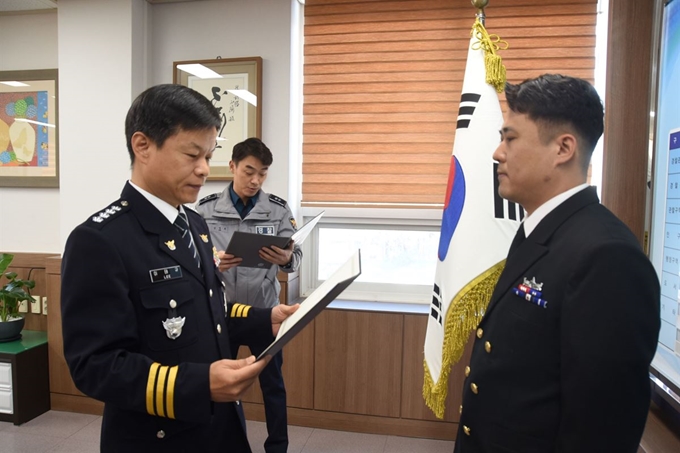 12일 이태규(왼쪽) 진해경찰서장이 해군 김동욱(오른쪽) 중사에게 보이스피싱 조직원 검거 공로 표창장을 수여하고 있다. 해군 제공