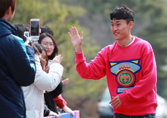 이진현이 18일 오후 경기도 파주시 축구대표팀트레이닝센터(NFC)에서 실시된 소집 훈련에 참가하기 위해 센터로 들어가며 팬들과 하이파이브를 하고 있다. 연합뉴스