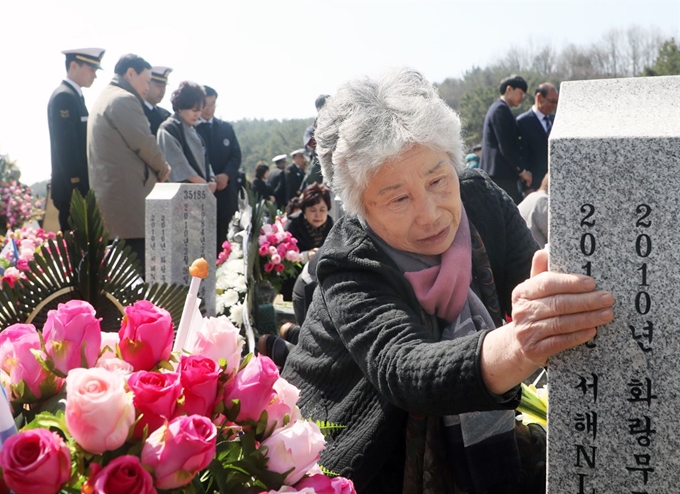 [2019-03-22T12_3563494] (대전=뉴스1) 주기철 기자 = 故 민평기 상사의 어머니 윤청자 여사가 22일 오전 국립대전현충원에서 열린 제4회 서해수호의 날 기념식을 마친 뒤 천안함 46용사 묘역 내 민상사의 묘비를 어루만지고 있다. 뉴스1