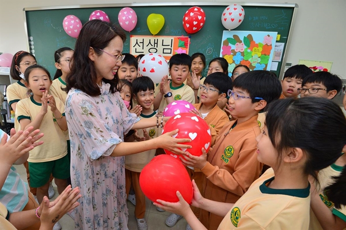 15일 경북 포항시 남구 제철지곡초등학교에서 학생들이 담임 선생님에게 하트 풍선을 선물하고 있다. 뉴스1