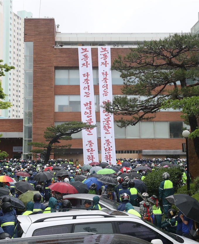 [PYH2019052716400005700] <YONHAP PHOTO-3594> 주주총회 열릴 건물 점거한 현대중공업 노조. 27일 오후 회사 물적 분할에 반대하며 울산시 동구 한마음회관을 점거한 현대중공업 노조가 건물 앞에 집결해 있다. 이 회관에서 오는 31일 현대중공업 주주총회가 열릴 예정이다.