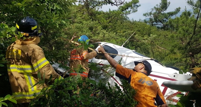 13일 오후 2시쯤 전남 여수시 소라면의 한 초등학교 뒷산에 훈련용 경비행기가 추락해 119 구조대원들이 구조 작업을 벌이고 있다. 여수소방서 제공