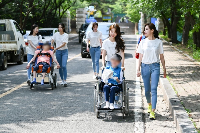 15일 오후 경기 김포에 위치한 중증장애인시설 가연마을을 찾은 2019 미스코리아 본선진출자들이 휠체어를 끌고 산책 봉사에 나섰다. 미스코리아 운영본부 제공.