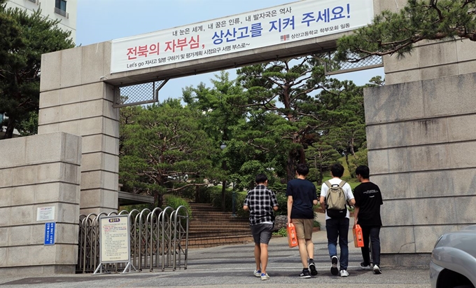 상산고의 자사고 재지정 평가 결과 발표를 하루 앞둔 19일 학생들이 ‘전북의 자부심, 상산고를 지켜 주세요!’라고 적힌 현수막이 걸린 학교 정문으로 걸어 들어가고 있다. 뉴스1