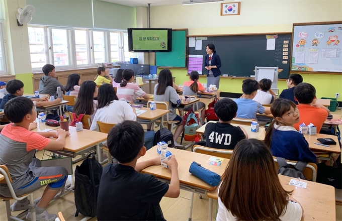 BNK경남은행이 지역 청소년을 위해 실시하고 있는 ‘1사1교 금융교육’이 큰 호응을 얻고 있다. 지난 19일 창원시 봉덕초등학교 5학년 학생들을 대상으로 한 금융교육 모습. BNK경남은행 제공