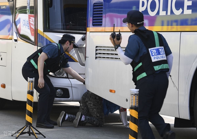 한 조합원이 경찰이 세운 차벽 밑으로 진입하려 하고 있다. 이한호 기자